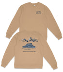 a tan sweatshirt with a graphic design depicting a cabin and mountains, along with the text "GRAND Teton NATIONAL PARK".