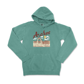 a green sweatshirt with the words arches on it