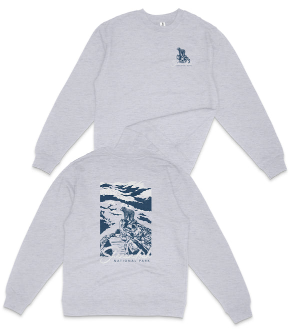 A grey long-sleeved shirt with a graphic design on the back, depicting a mountain landscape with a person riding a horse.