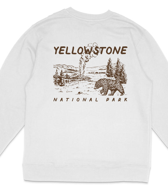 A white long-sleeved shirt with a graphic design depicting a bear and a landscape with a steam vent in Yellowstone National Park.