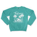 a turquoise sweatshirt with a palm tree and a wave in the ocean