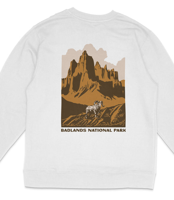 A white sweatshirt with a graphic design depicting a mountain landscape with a bighorn sheep in the foreground.
