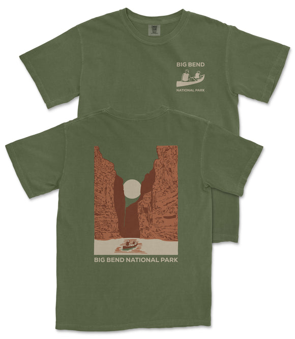 A green t-shirt with a graphic design depicting a canyon landscape and a boat on a river, along with the text "BIG BEND NATIONAL PARK".