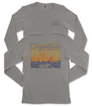 a gray long-sleeved t-shirt with a graphic design depicting a scenic landscape, including mountains and a body of water.