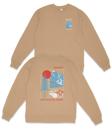a tan sweatshirt with a graphic design on the back, depicting a mountain landscape with a red sun and blue sky.