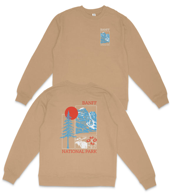 a tan sweatshirt with a graphic design on the back, depicting a mountain landscape with a red sun and blue sky.