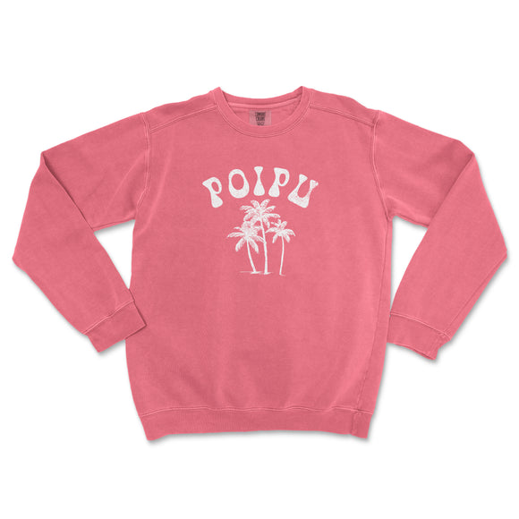 a pink sweatshirt with palm trees printed on it