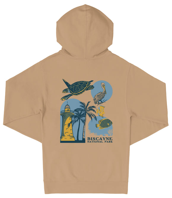 A beige hoodie with a graphic design featuring various sea creatures, including a turtle, a bird, and a palm tree, along with the text "Biscayne National Park".