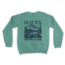 a green sweatshirt with a mountain scene on it