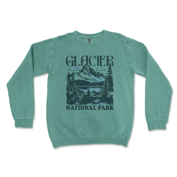 a green sweatshirt with a mountain scene on it