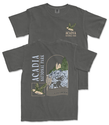 a gray t-shirt with a graphic design depicting a scenic view of Acadia National Park, including a mountain, trees, and a bird.