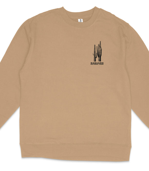 A beige long-sleeved shirt with a small graphic design on the front.