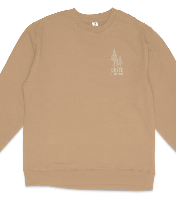 A beige long-sleeved shirt with a small white graphic on the left side.