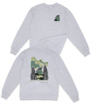 a gray sweatshirt with a graphic design depicting a forest scene with trees and a mountain in the background.
