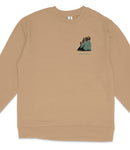 A beige long-sleeved shirt with a small graphic design on the front depicting a mountain landscape with trees.