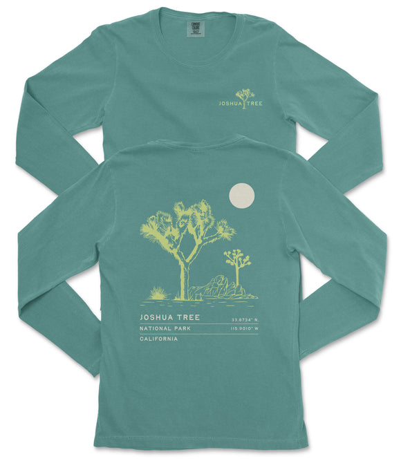 a teal long-sleeve t-shirt with a graphic design depicting a tree and a moon on the back.