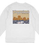 A white long-sleeved shirt with a graphic design depicting a desert landscape with mountains and a body of water.
