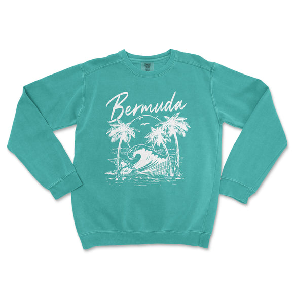 a turquoise sweatshirt with a white graphic of a wave and palm trees