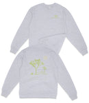 a grey long-sleeved shirt with a graphic design on the back, depicting a tree and a moon.