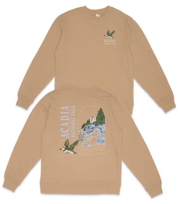 a tan sweatshirt with a graphic design on the back, depicting a bird and a landscape with trees.
