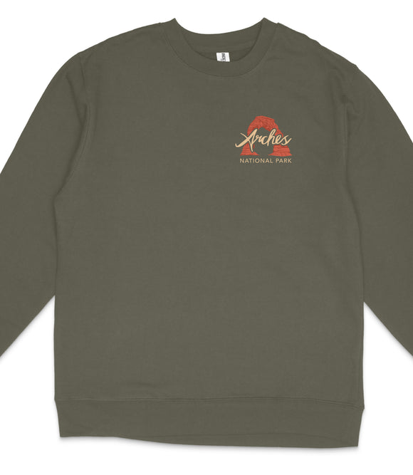 A dark green long-sleeved shirt with a logo on the left side.