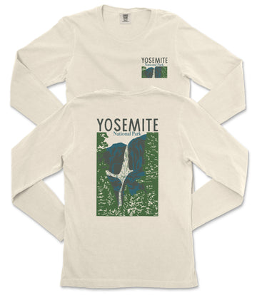 A white long-sleeved t-shirt with a graphic design depicting a waterfall and mountains, along with the text "Yosemite National Park" printed on it.