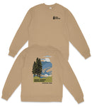 a beige sweatshirt with a graphic design depicting a mountain landscape with pine trees and a cloudy sky.