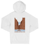 A white hooded sweatshirt with a graphic design depicting a canyon landscape with a boat in the foreground.