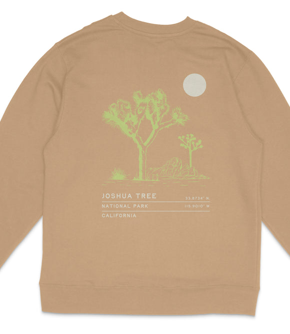 a tan sweatshirt with a graphic design depicting a Joshua tree and a moon.