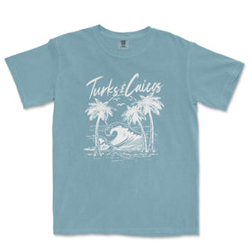 a blue t - shirt with a picture of a wave and palm trees