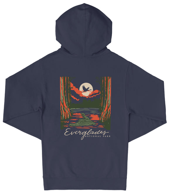 A navy blue hooded sweatshirt with a graphic design depicting a nighttime scene with a full moon, a bird, and a forest landscape.