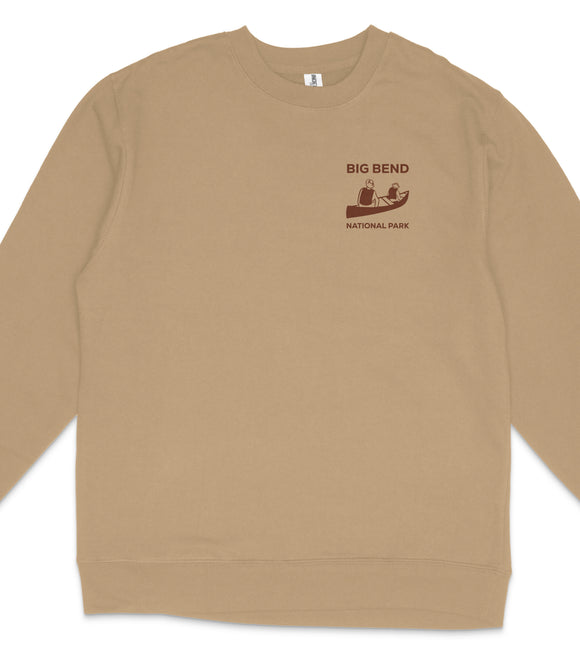 A tan long-sleeved shirt with a graphic design on the left side, depicting a person in a canoe and the text "BIG BEND NATIONAL PARK".