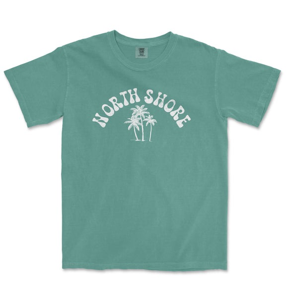 a green north shore t - shirt with palm trees