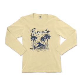 a women's long sleeve shirt with a picture of a surfer on the beach