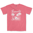 a pink shirt with a picture of a wave and palm trees