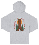 A gray hooded sweatshirt with a graphic design featuring a redwood tree and the text "REDWOOD NATIONAL PARK NORTHERN CALIFORNIA".