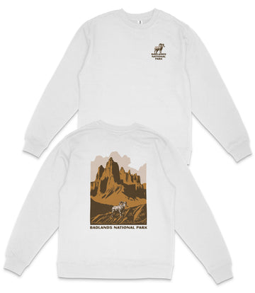 a white long-sleeved shirt with a graphic design depicting a mountain landscape and a horse. The design includes the text "BADLAND'S NATIONAL PARK" printed on the back of the shirt.