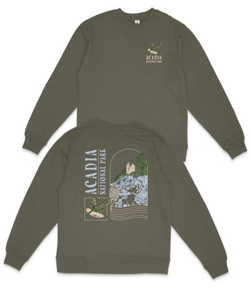 a grey sweatshirt with a graphic design on the back, depicting a scenic landscape with a castle, trees, and mountains.