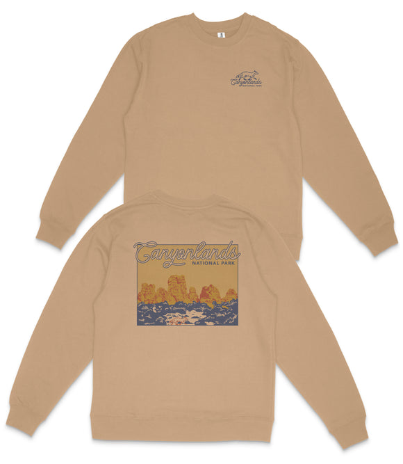 a tan sweatshirt with a graphic design on the back, depicting a scenic landscape with mountains and water.
