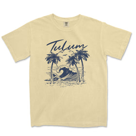 a yellow t - shirt with a picture of a wave and palm trees