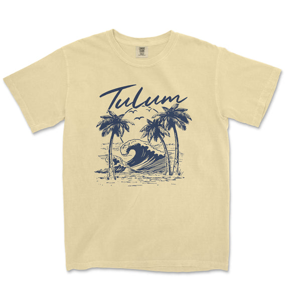 a yellow t - shirt with a picture of a wave and palm trees
