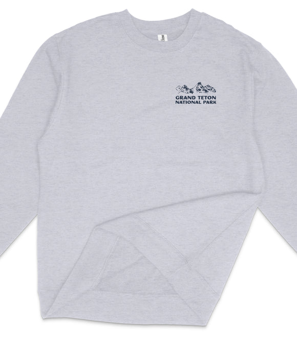 A gray long-sleeved shirt with a logo on the left side.