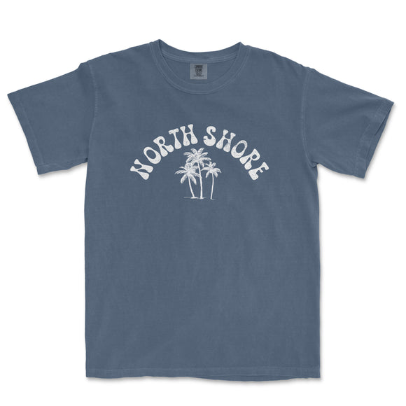 a blue north shore t - shirt with palm trees