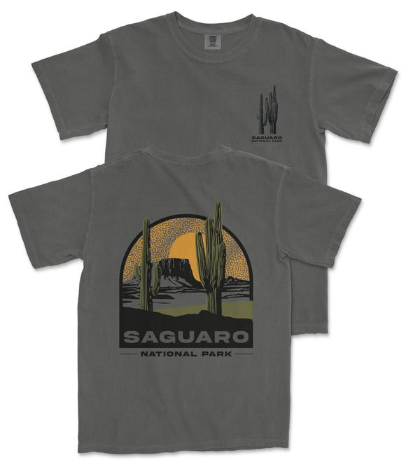 a gray t-shirt with a graphic design depicting a desert landscape with cacti and mountains, along with the text "Saguaro National Park".