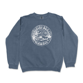 a blue sweatshirt with a white seal on it