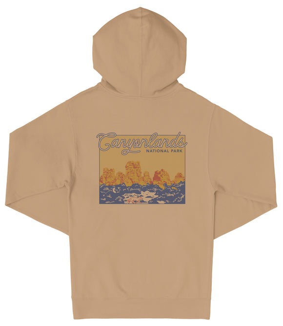 A beige hooded sweatshirt with a graphic design depicting a scenic landscape with mountains and water.