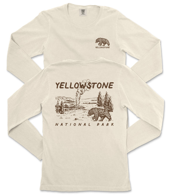 A cream-colored long-sleeved t-shirt with a graphic design depicting a bear and a landscape, along with the text "Yellowstone National Park" printed on the back.