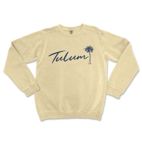 a white sweatshirt with the word tulum written in blue ink