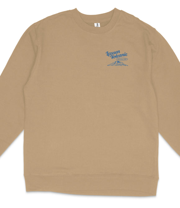 A tan long-sleeved shirt with a blue logo on the left side.