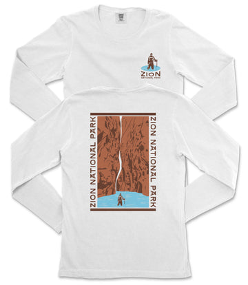 A white long-sleeved t-shirt with a graphic design depicting a person standing on a cliff overlooking a waterfall.